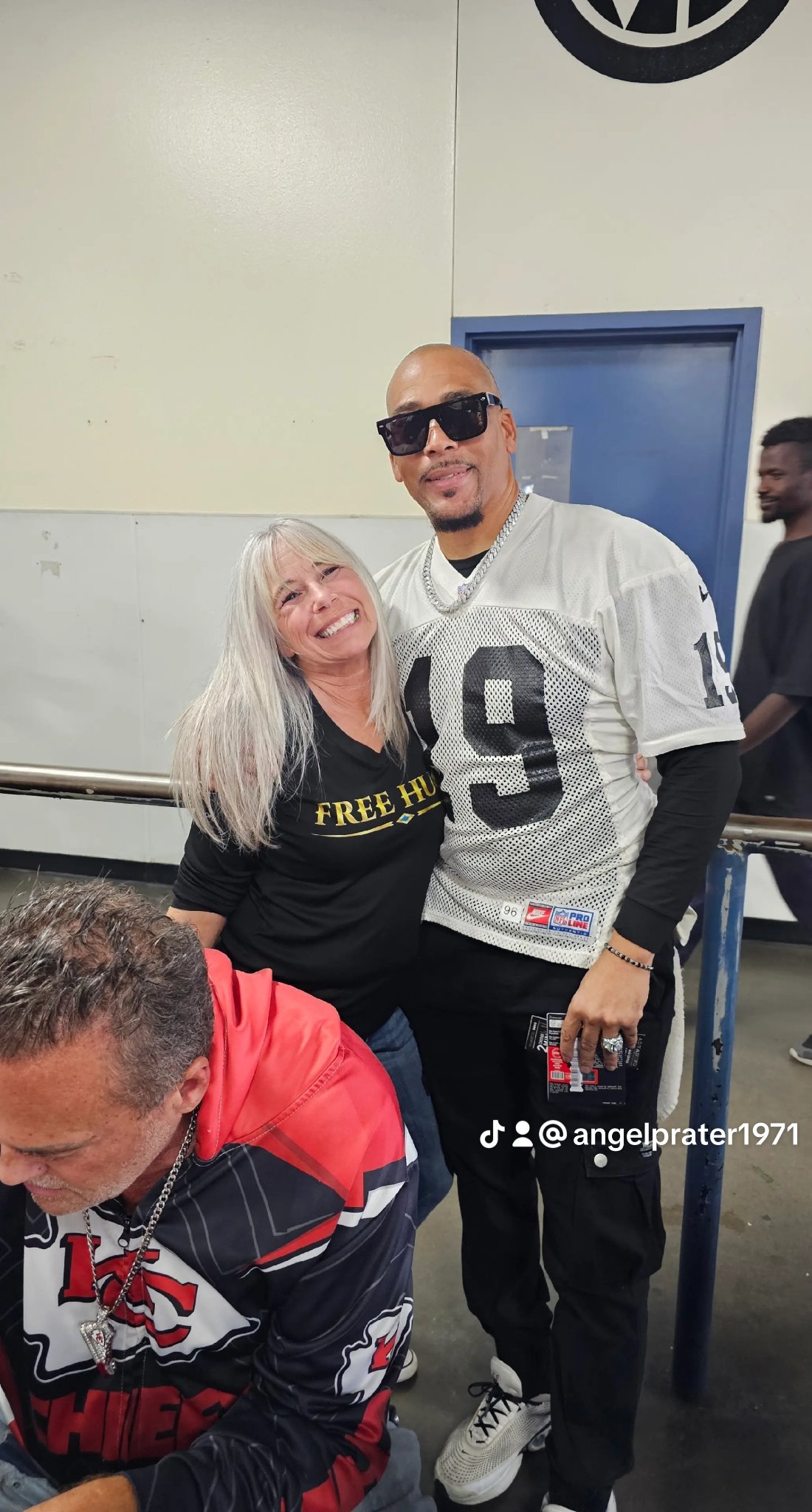 Angel Prater in a FREE HUGS shirt with former NFL Raider AC Caswell at a Champions for the Homeless event