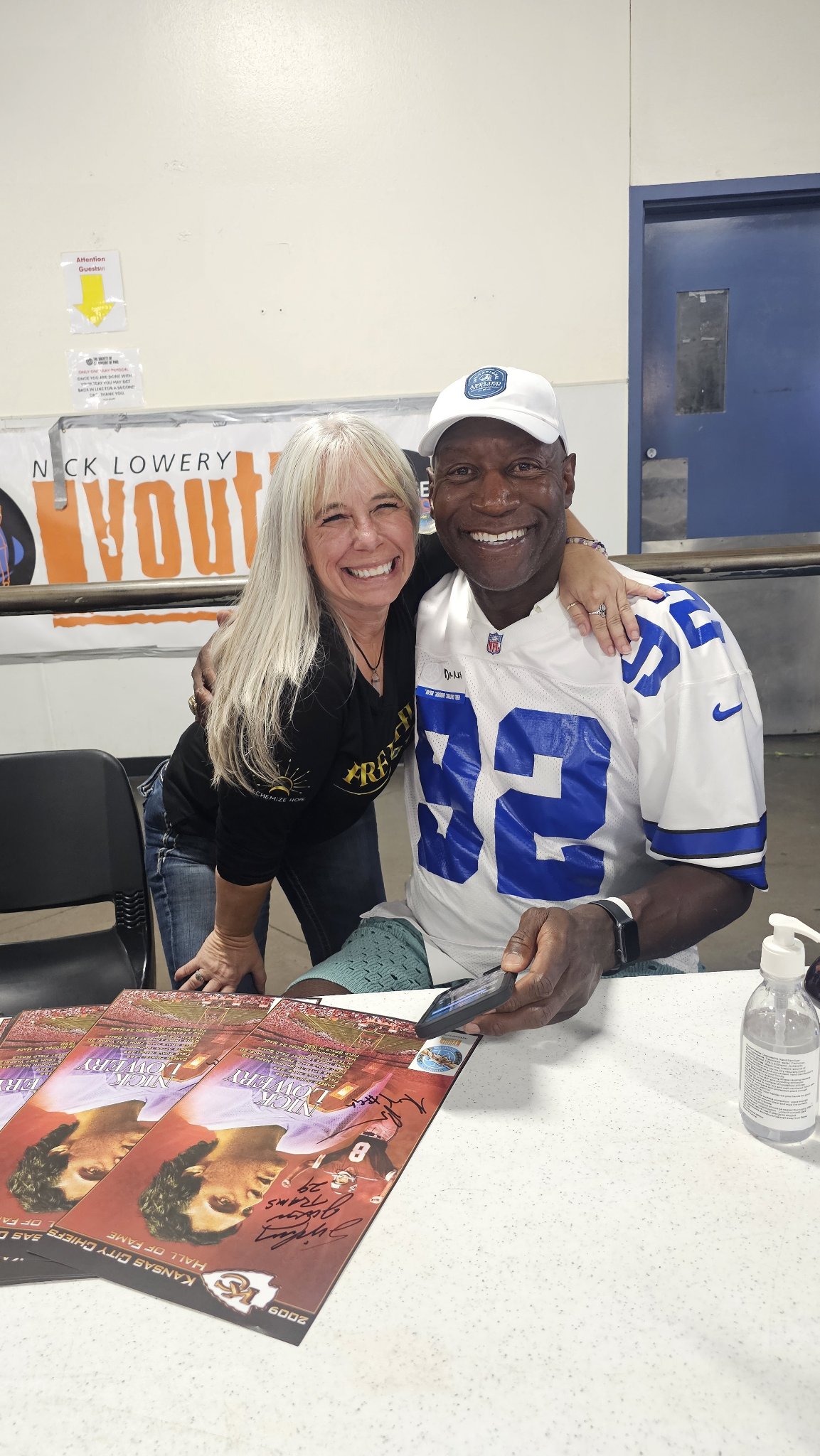 Angel Prater at a signing table at a Champions for the Homeless event