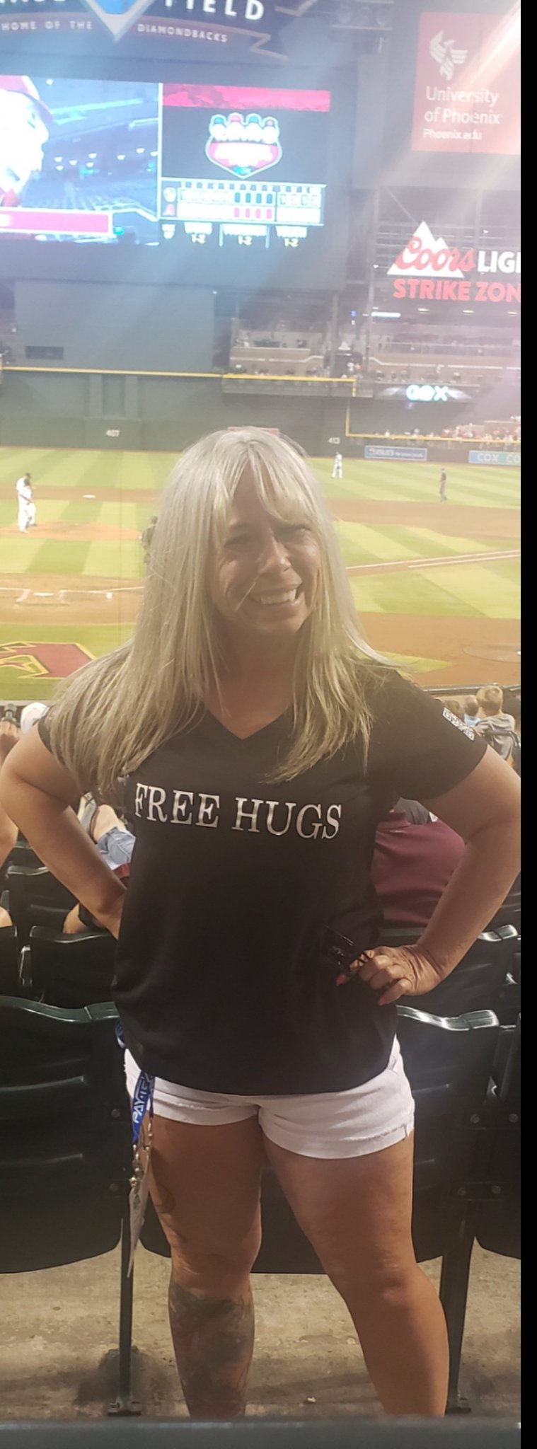 Angel Prater in a FREE HUGS shirt in the stands at Chase Field during an Arizona Diamondbacks game in Phoenix