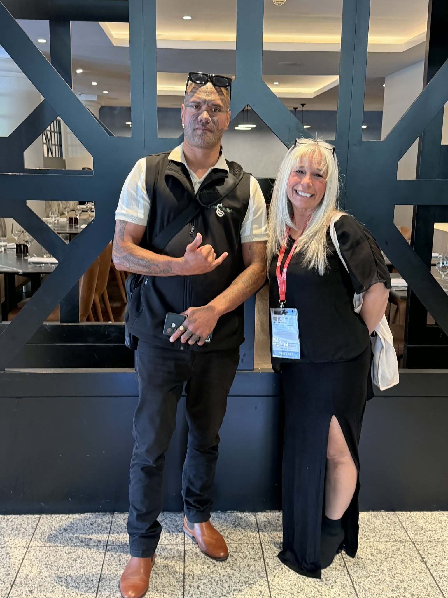 Angel Prater wearing a delegate badge, with a fellow conference delegate