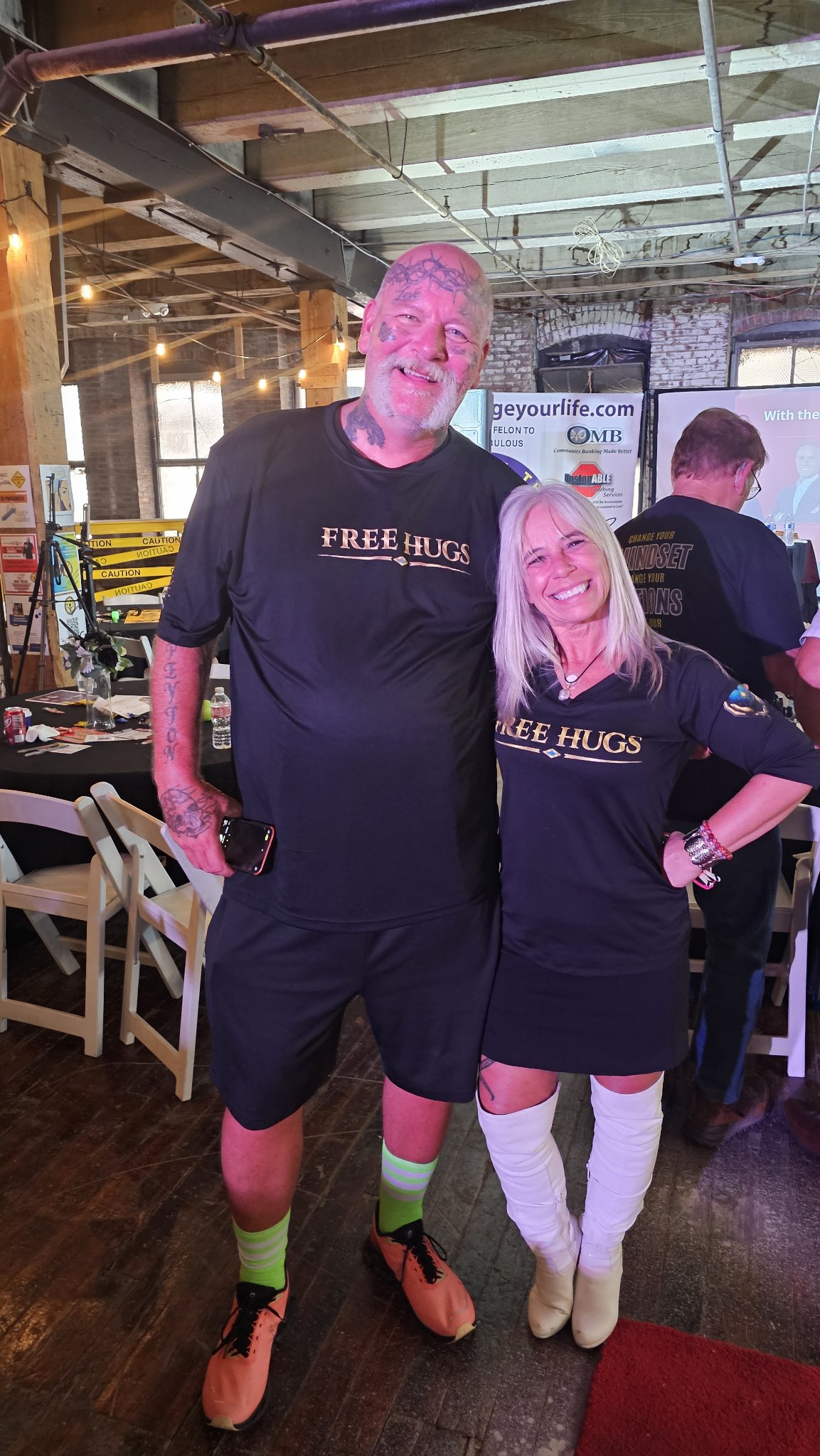 Angel Prater with John Drury, both wearing FREE HUGS shirts