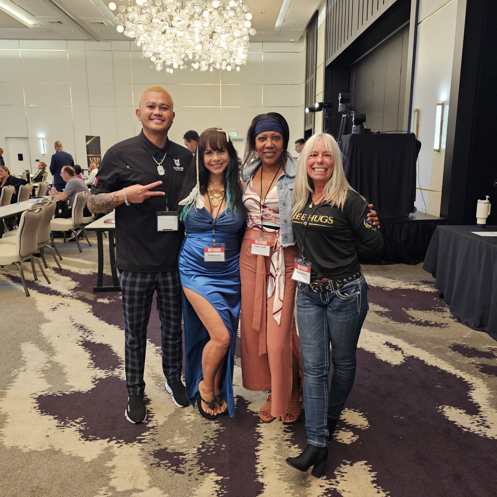 Angel Prater in a FREE HUGS shirt with fellow attendees at 10X Stages