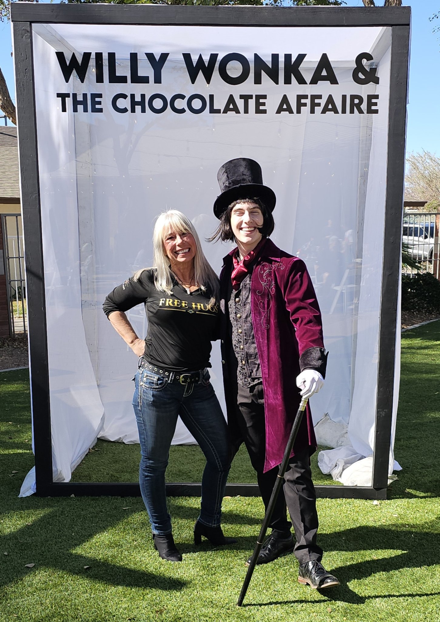 Angel Prater in a FREE HUGS shirt with Willy Wonka at Willy Wonka and The Chocolate Affaire