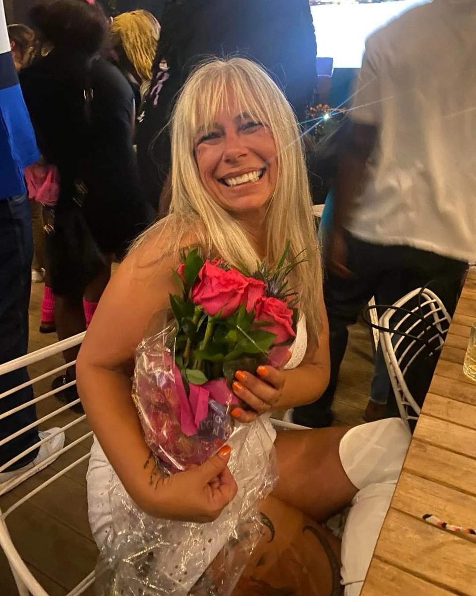 Angel Prater, CEO/Founder — holding pink roses