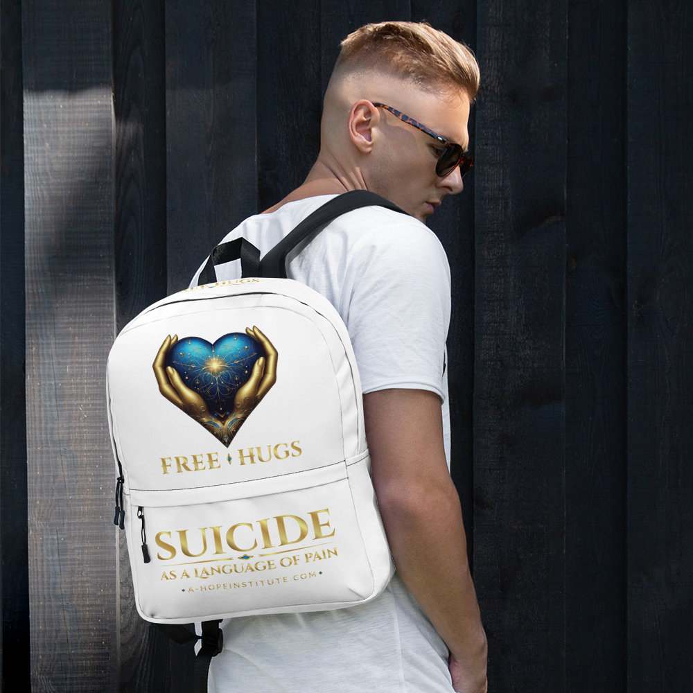 Young man with sunglasses wearing the white FREE HUGS backpack against a dark wood wall